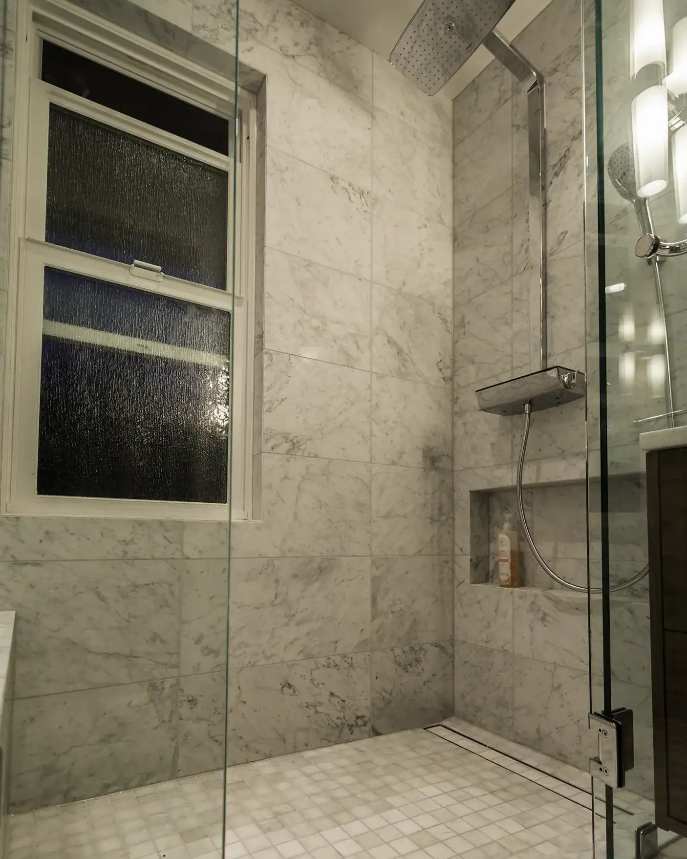 Marble tile walk-in shower with linear drain and rain head