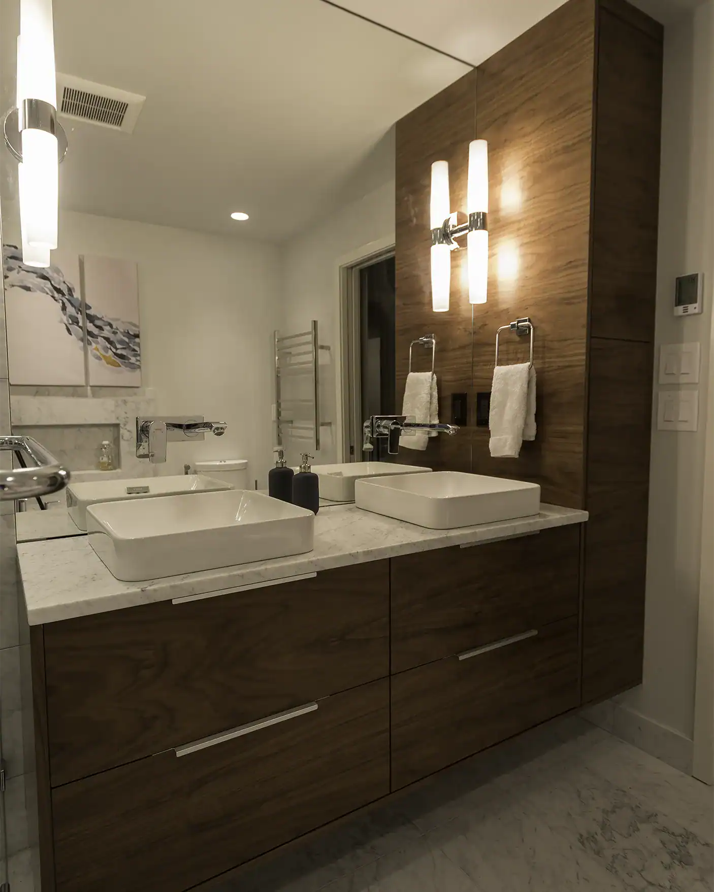 Gig Harbor master bath with floating walnut vanity and wall-mounted faucets