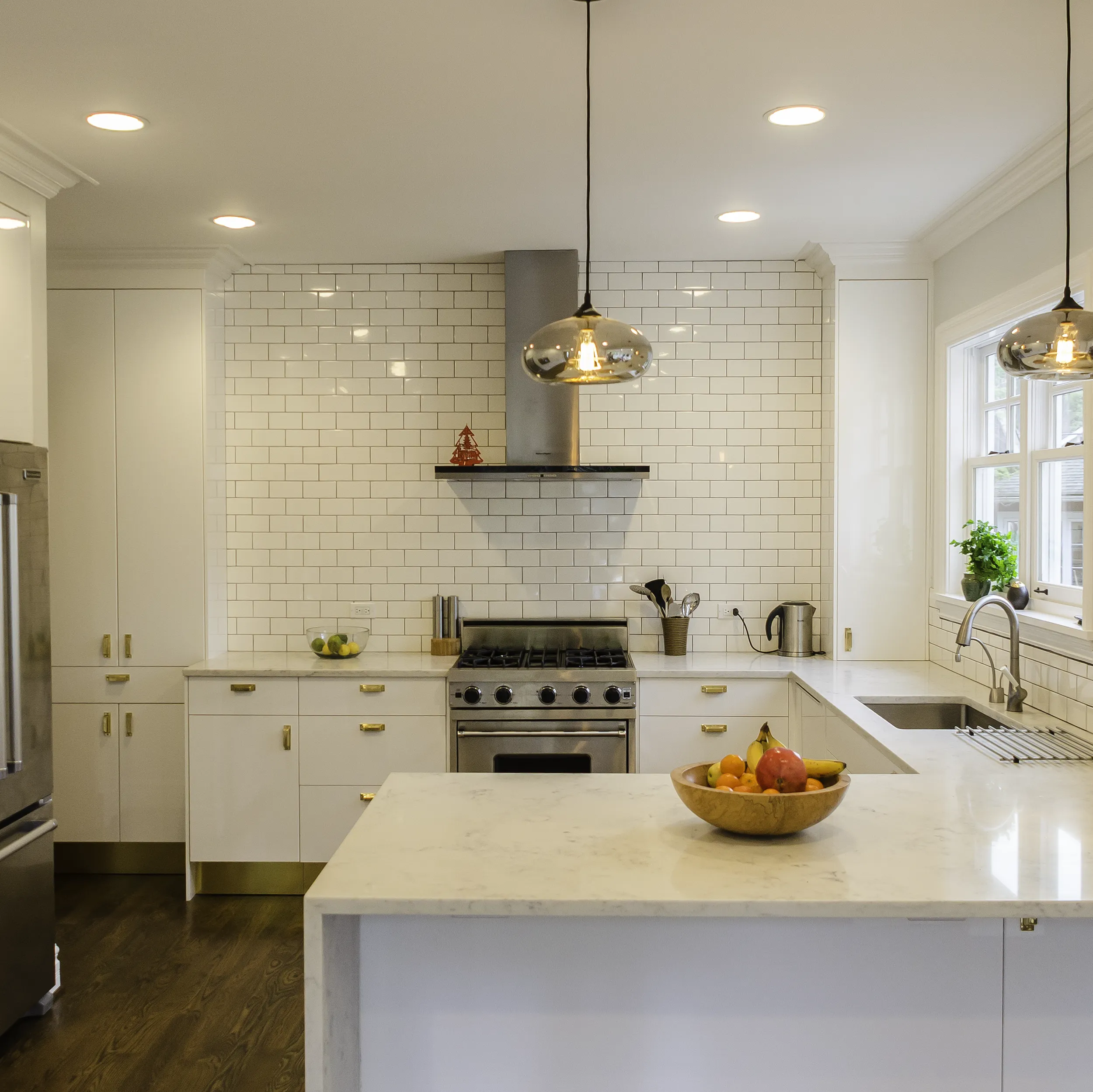Modern IKEA kitchen with high gloss white cabinets and brass hardware