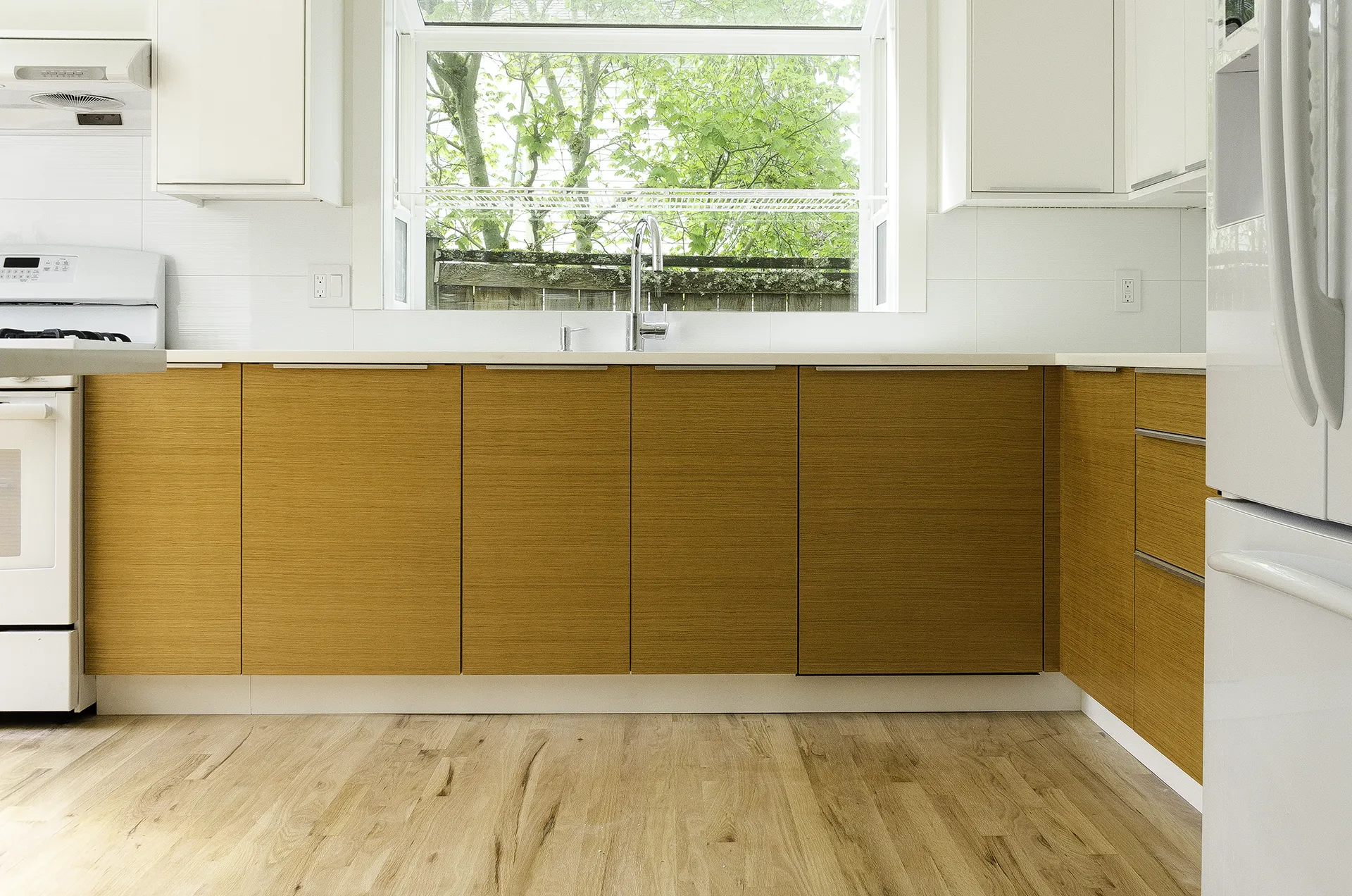 IKEA kitchen remodel in Issaquah with custom fir cabinet doors, white countertops, and light wood flooring