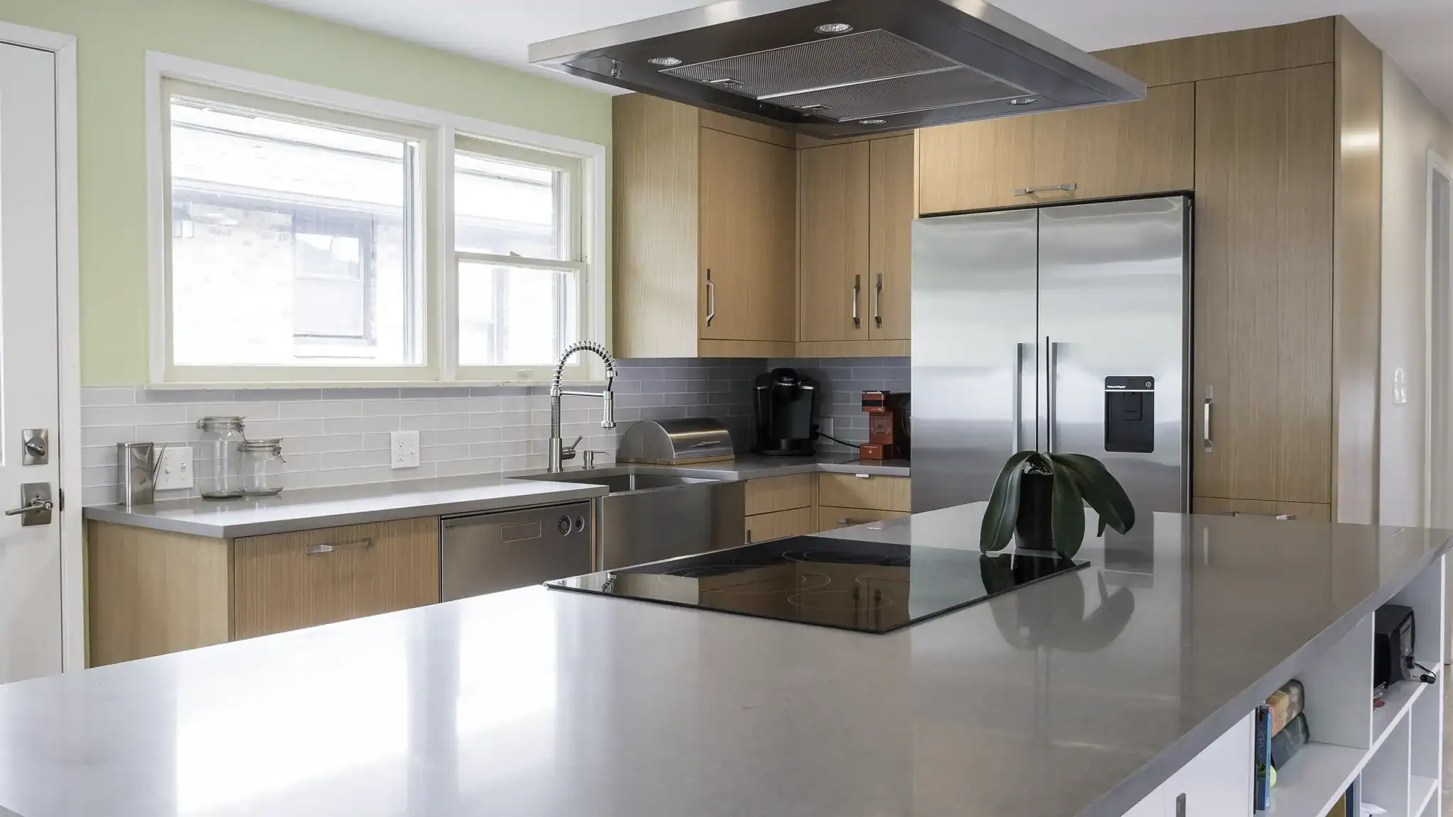 NW Homeworks kitchen remodel in Ravenna with custom VG fir cabinets, grey quartz countertops, and induction cooktop