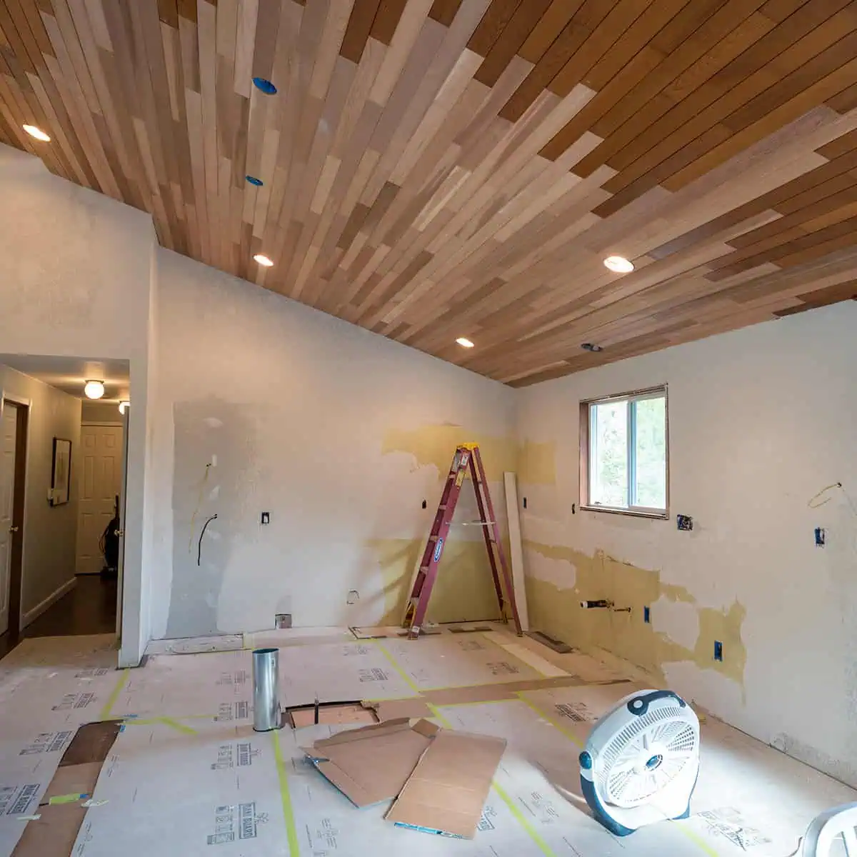 Kitchen remodel in progress showing exposed framing and vaulted ceiling work