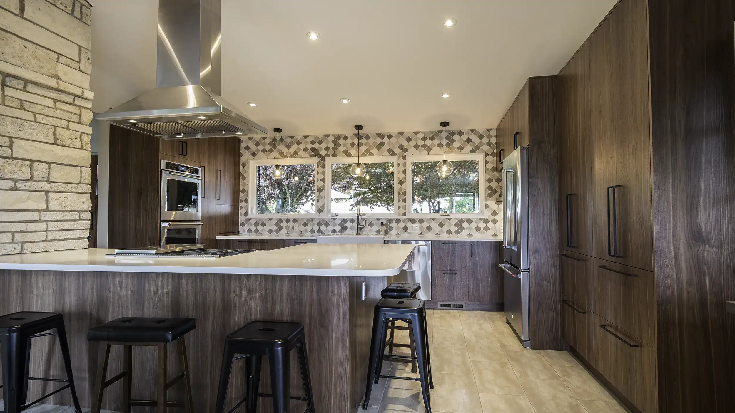 Completed Normandy Park kitchen remodel — dark walnut cabinets, rustic stone, black hardware