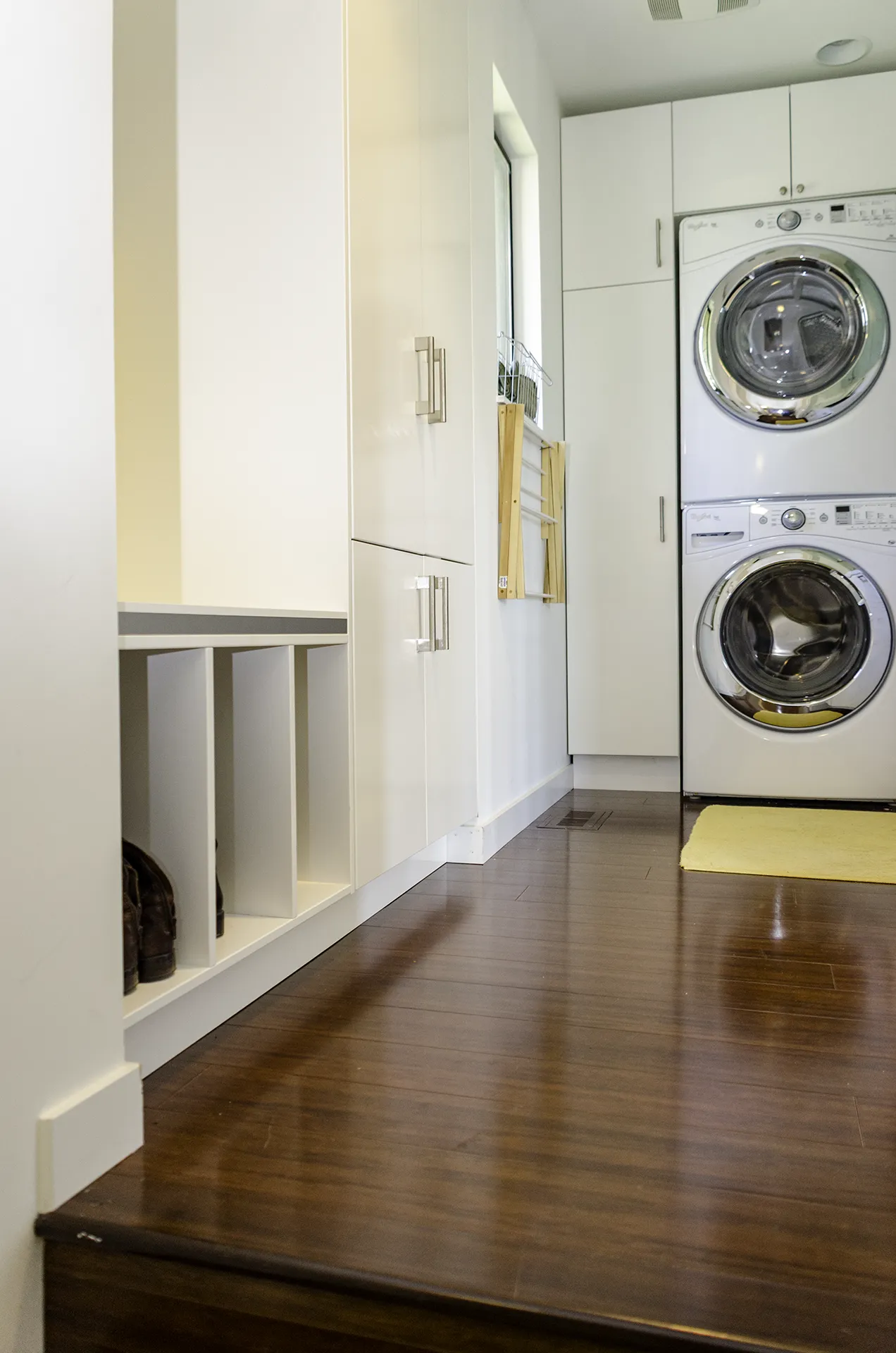 Kirkland laundry room remodel with IKEA cabinets, built-in bench with cubbies, and stacked washer-dryer