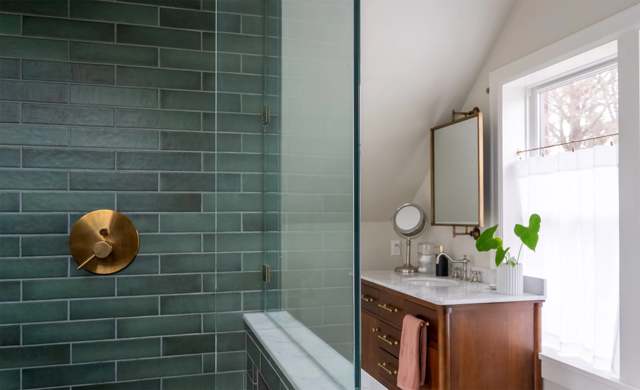 Maple Leaf master bathroom remodel with marble tile and brass fixtures