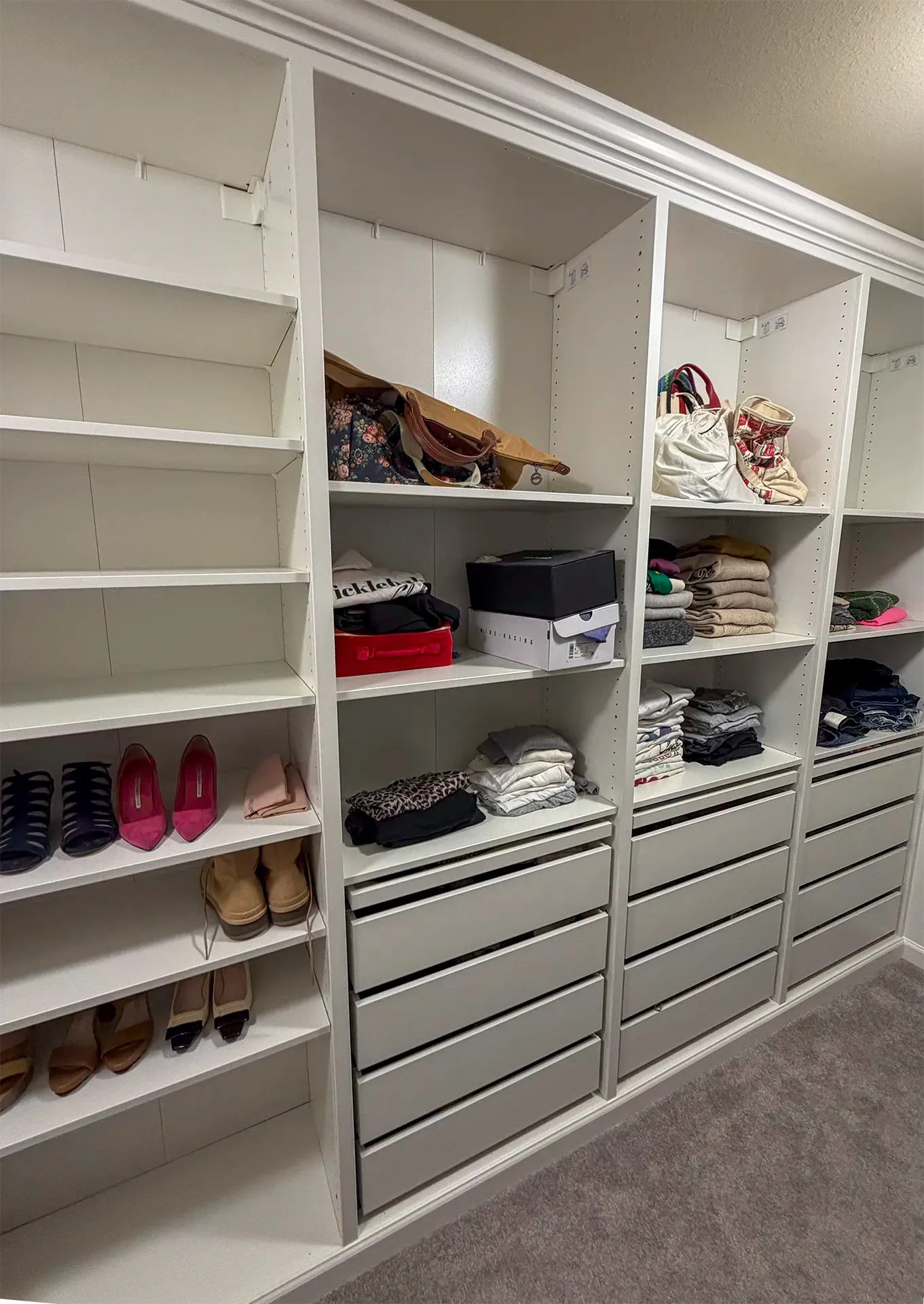 Master bedroom walk-in closet built from the IKEA PAX system in Medina, WA