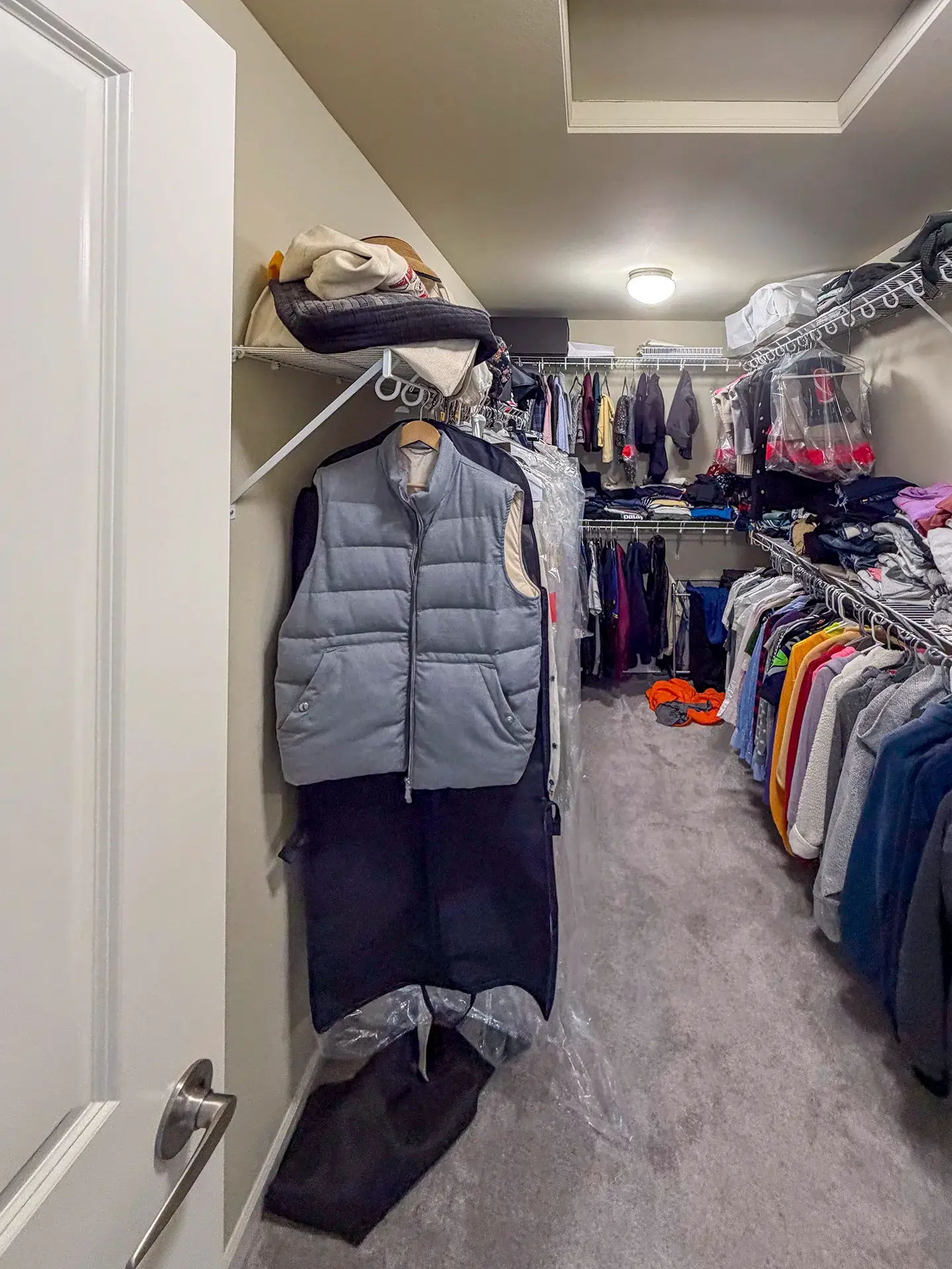 Closet before the remodel with basic wire shelving and a single hanging rod
