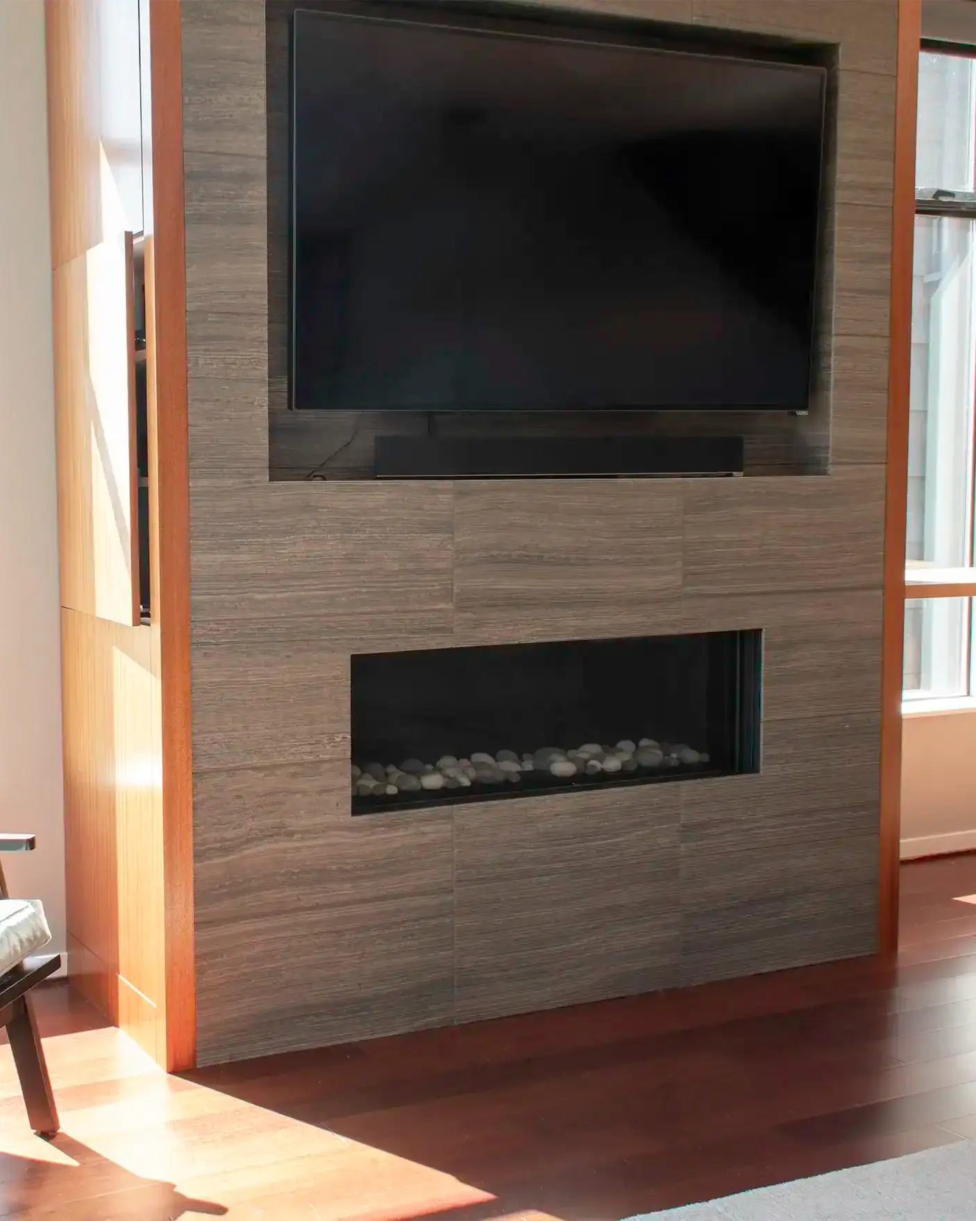 Media wall with a recessed inset TV, linear fireplace and hidden component storage
