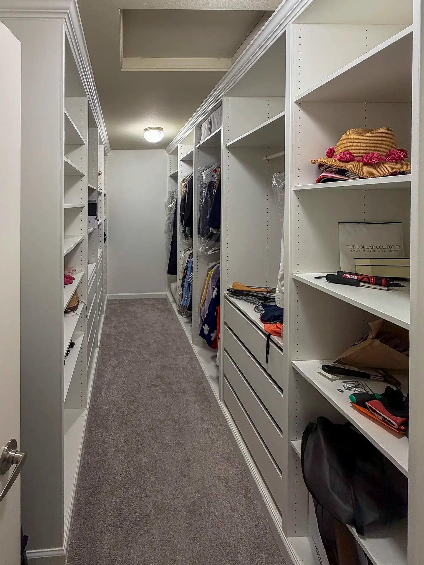Walk-in closet with a drawer bank, shoe shelves and double-hung hanging space