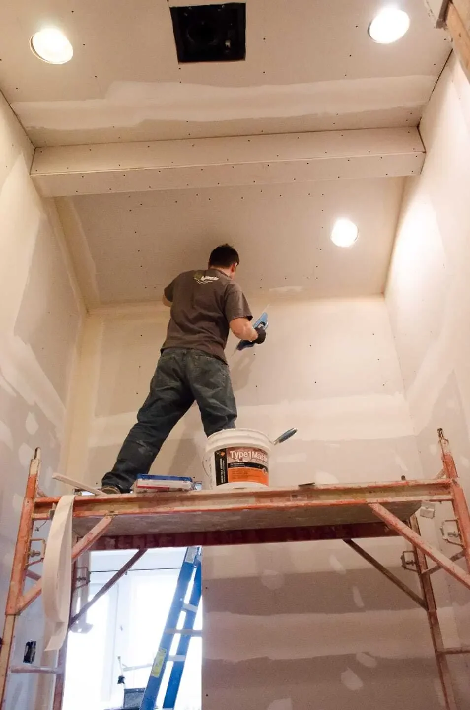 Applying the drywall finish after re-framing of bathroom