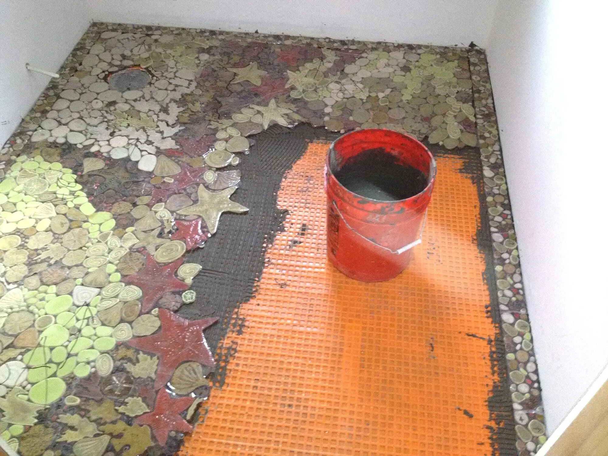 Tile mosaic installation in progress