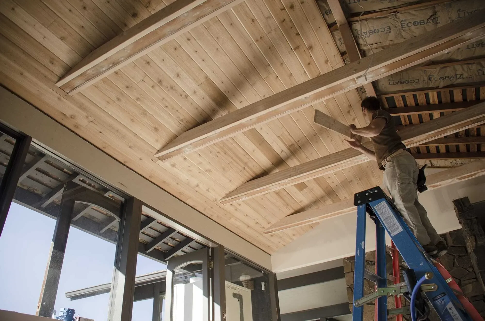 Installation of tongue and groove cedar cladding on the ceiling