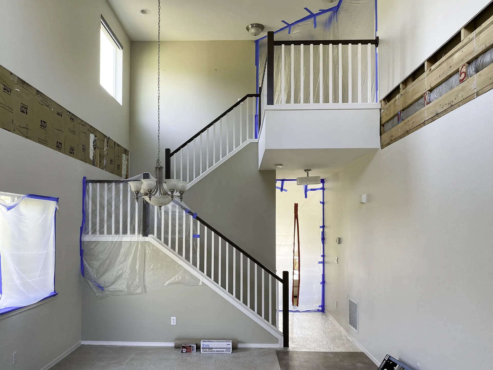 Drywall removed around perimeter to expose framing for new rim joists