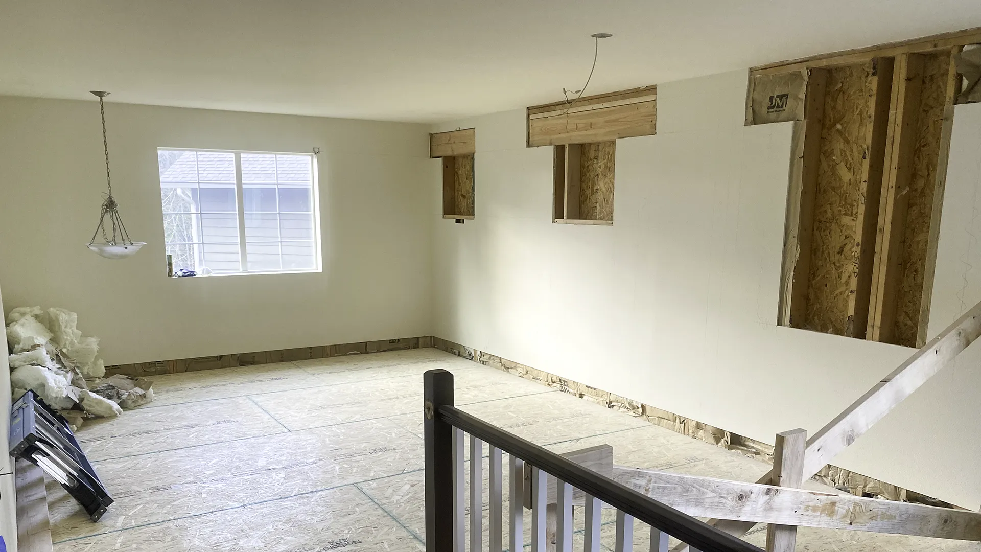 New window openings framed with 6x8 headers in the new second-floor bedroom