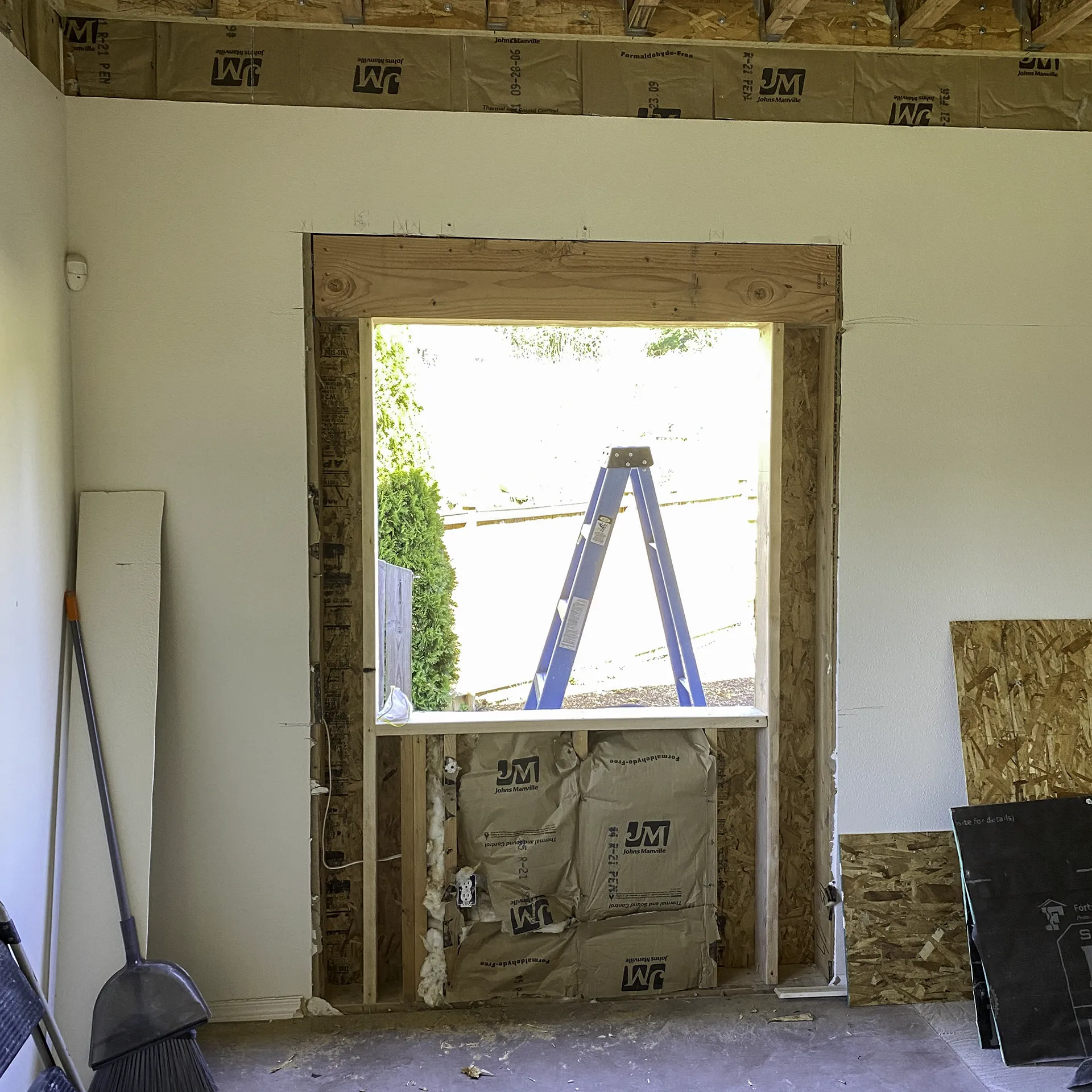 New large window opening being framed on the first floor living room