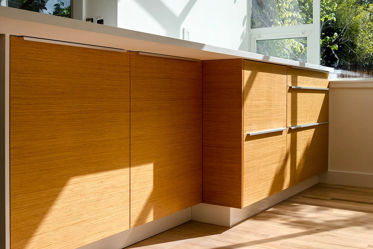 Custom flat-panel kitchen cabinet doors with horizontal grain and aluminum pulls, Seattle remodel