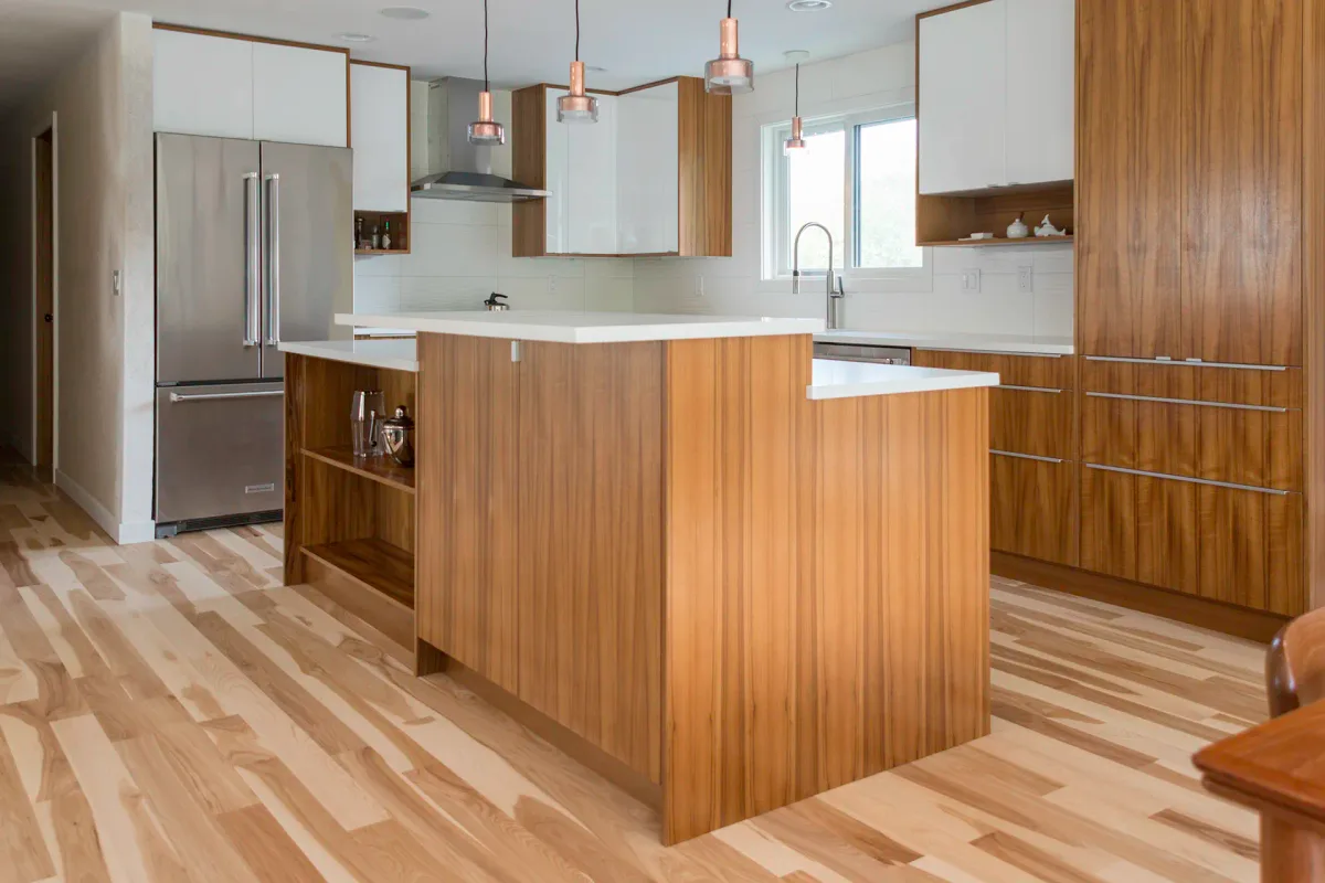 Hickory hardwood flooring in Seattle kitchen remodel with walnut island and white upper cabinets