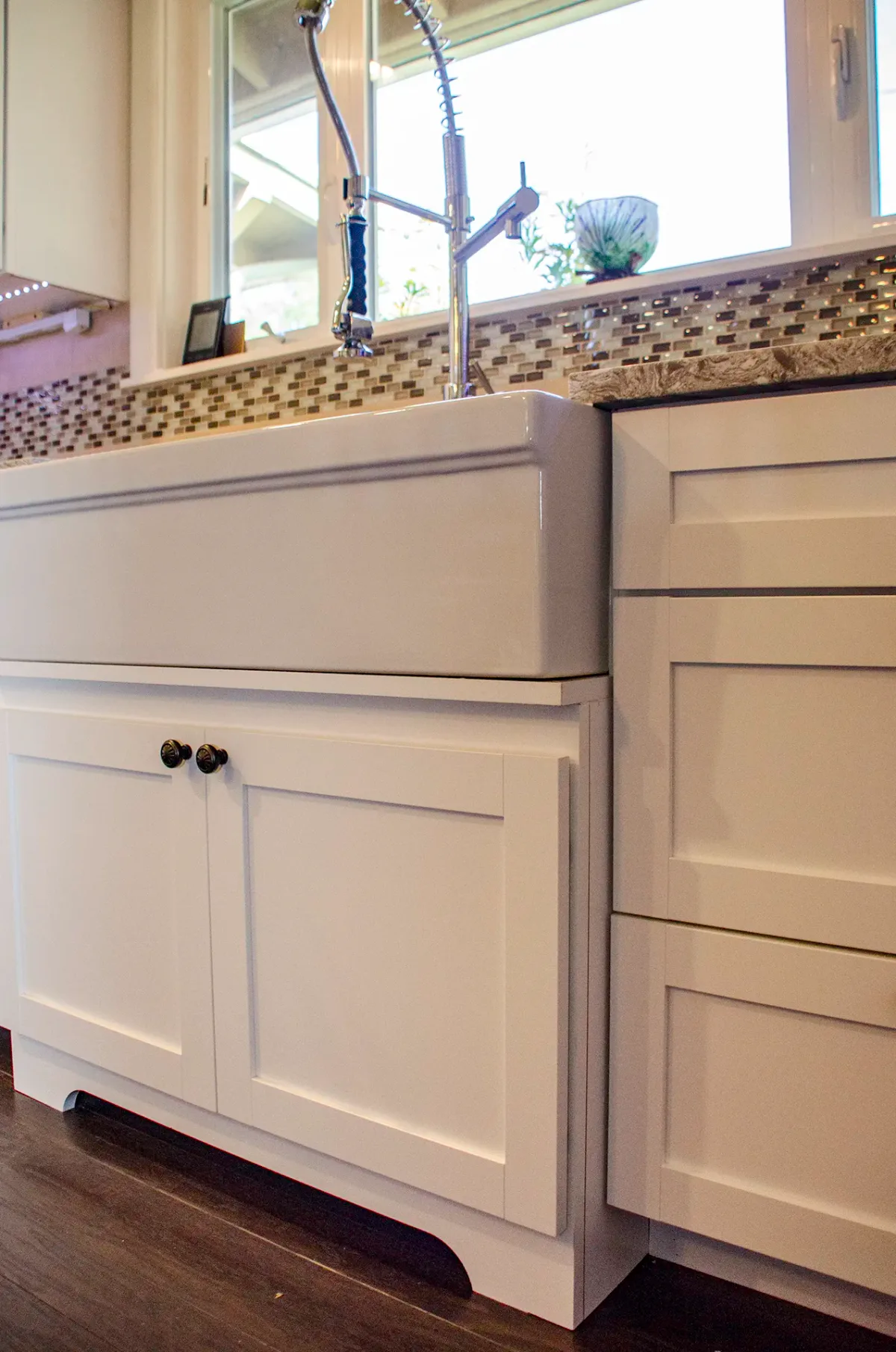 Porcelain farmhouse sink with professional faucet in Seattle kitchen remodel