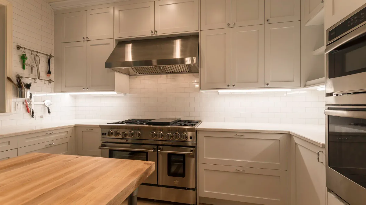 Professional BlueStar range with commercial hood and under-cabinet lighting in Redmond kitchen remodel