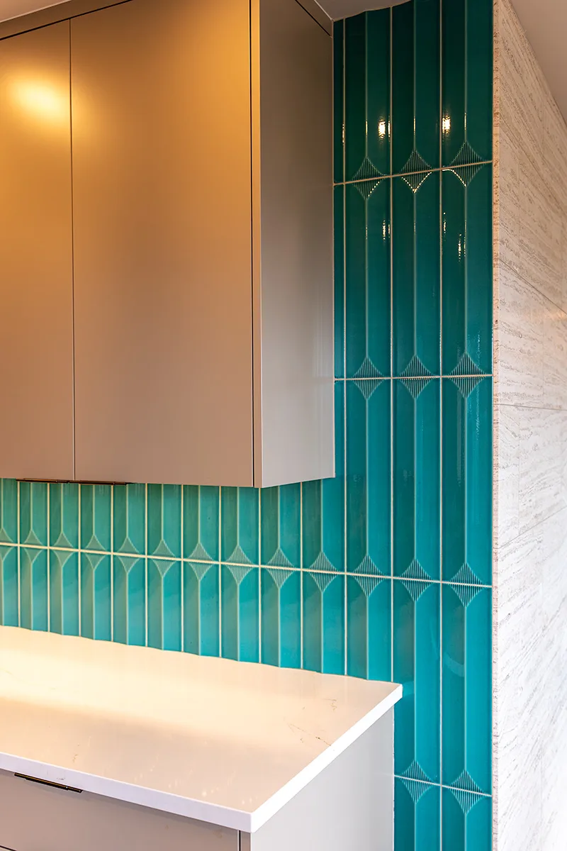Geometric teal tile backsplash installation in Seattle kitchen remodel